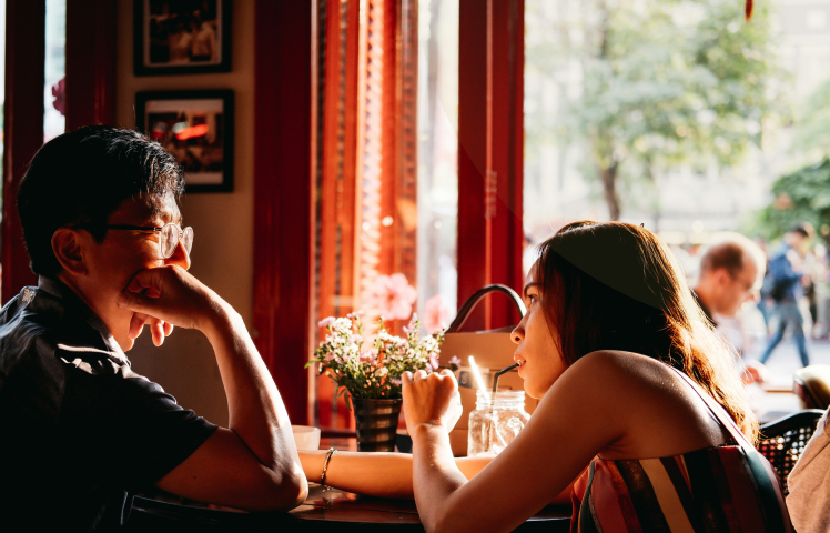 Two singles talking over a drink